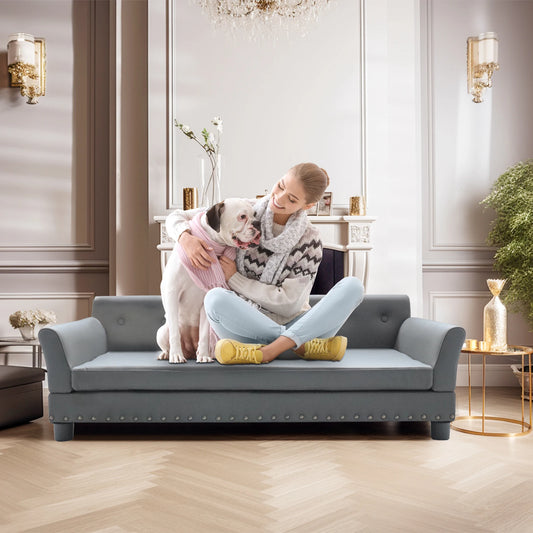 Woman hugging a dog on a gray pet bed in a stylish room.