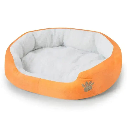 Soft fleece dog bed in orange color with plush grey interior, perfect for dogs and cats.